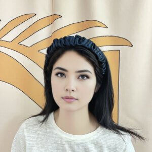 A lady wearing a wide silk headband