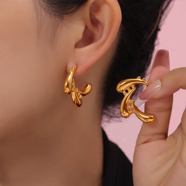 Model wearing gold earrings