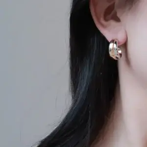 Model wears minimalist mirrored earrings