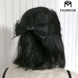 Model wears a tulle bow hairpin